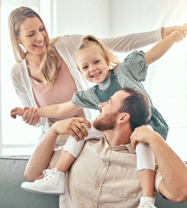 Happy family playing outdoors, parents with child in nature